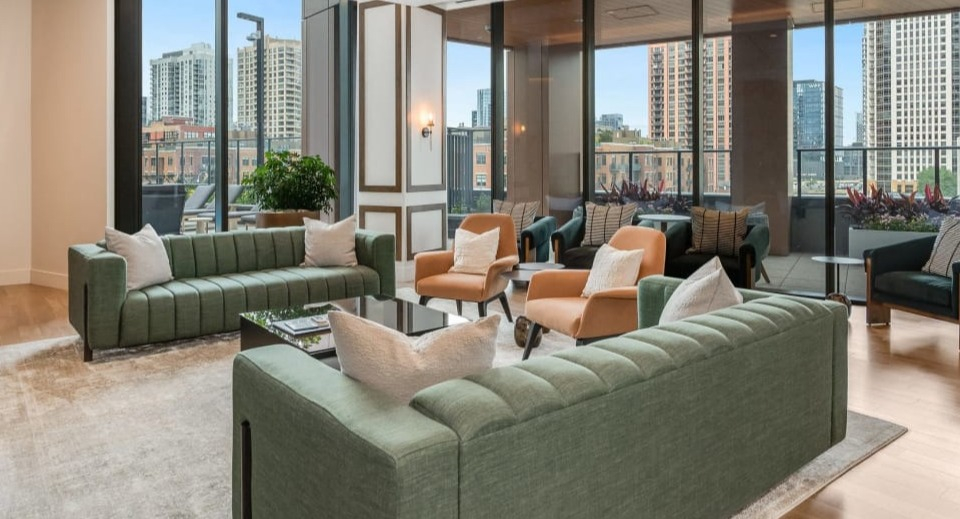 Spacious resident lounge with comfortable seating, modern furnishings, and large windows that offer stunning city views at Cassidy on Canal in Chicago